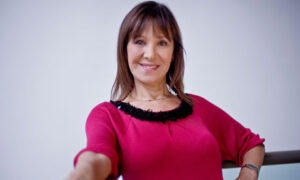 Smiling woman in a red sweater.